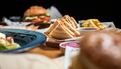 hamburgers in a cafe in a composition with pizza, salad, potatoes