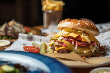 hamburgers in a cafe in a composition with pizza, salad, potatoes