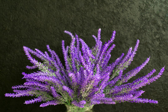  Bouquet of lavender flowers on a black background. Copy space.