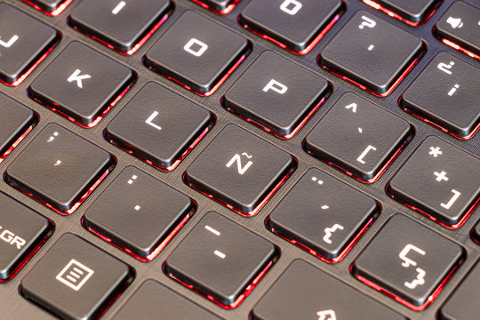 Spanish keyboard laptop focused in the characteristic letter Ñ of the Spanish alphabet and with illuminated keys