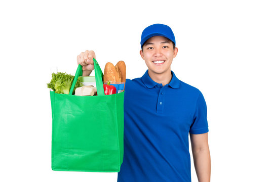 Smiling Handsome Asian Delivery Man Holding Grocery Shopping Bag Isolated On White Background