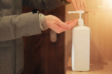 Desinfecting hands after returning from street. Woman sanitaze her hands outwear