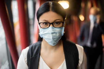 asian businesswoman in formal wear with medical mask looking  at camera