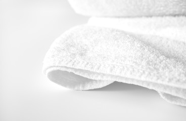 Fototapeta na wymiar Close-up clean bath towel on white background with copy space and selective focus. Concept health care spa and hygiene. Domestic bathroom, indoors