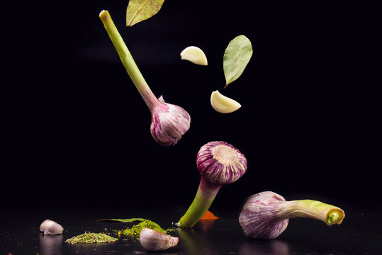 Garlic and spices with reflection isolated on a black background