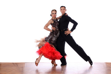 Latino dancers in ballroom against white background
