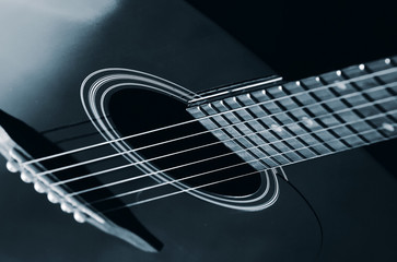 black acoustic guitar close up