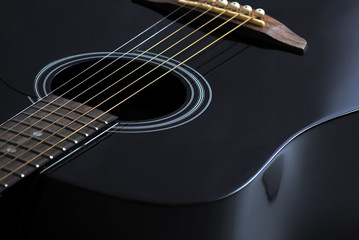 Fototapeta na wymiar black acoustic guitar close up