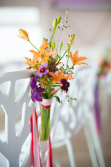 weddingflower arrangement in orange, pink and purple