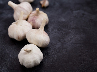 Free space for text with clove of garlic on dark concrete background