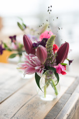 Wedding flower arrangement with lilies in shades of white and pink combined with other flowers