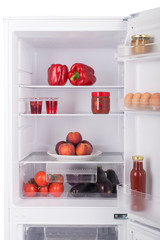 Open fridge full of fresh fruits and vegetables