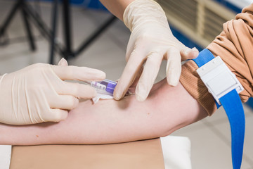 Covid-19, pandemic and viruses concept - Close-up of doctor takes blood on the analysis.