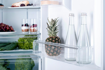 Open fridge full of fresh fruits and vegetables