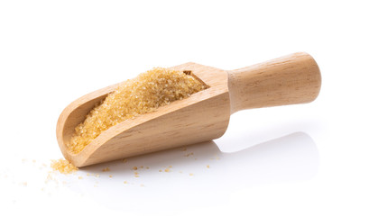 brown sugar in wood scoop on white background