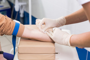 Covid-19, pandemic and viruses concept - Close-up of doctor takes blood on the analysis.