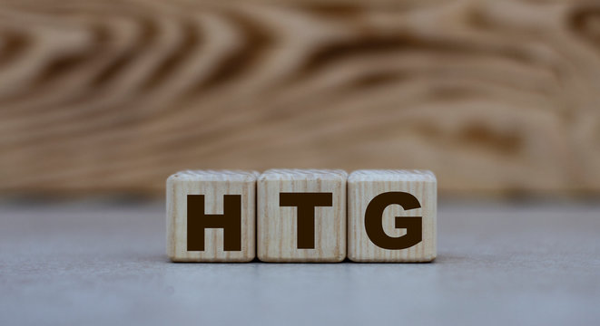 concept of the word HTG on cubes on a gray background with letters