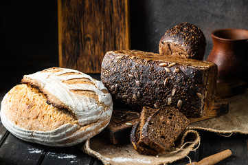 Assortment of baked goods on wood background. Rye bread. Wheat bread. Vegeterain food concept....