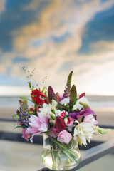 Wedding flower arrangement with lilies in shades of white and pink combined with other flowers