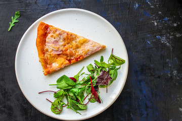 slice pizza and salad leaves in a plate on the table (tasty snack) menu concept background. top view. copy space for text