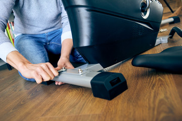 man assembling a stationary bicycle