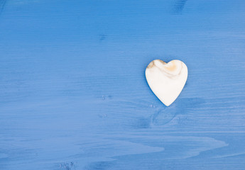 Fototapeta premium Valentine background. Marble Heart on an blue wooden table. Copy space