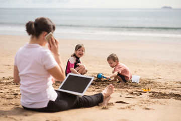 Hardworking mother balancing work-life, talking to clients over call.