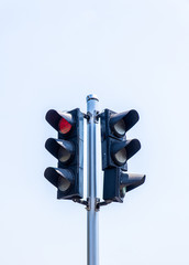 Red traffic light with blue sky background	