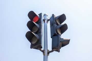 Red traffic light with blue sky background	