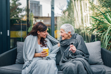 Family of different age generations enjoying together in home garden.