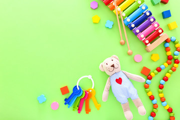 Obraz premium Colorful kids toys on green background. Top view, copy space