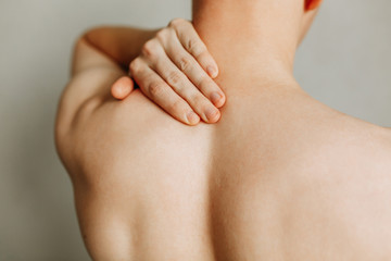 Fototapeta premium Injuries to the spine and lower back, fatigue at work. Area of the injury, the image on a clean background. Spasm on the man's back.