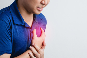 Asian man are chest pain with torture face in grey background. Heart disease, pneumonia, viral,...