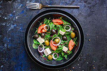 healthy salad olives, lettuce, tomato and cheese feta (greek salad, tasty vegetables snack) menu concept background. top view. copy space for text