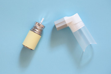 Inhaler on a blue background. The cure for asthma.