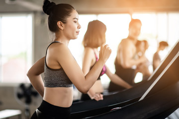 Fototapeta na wymiar Young healthy woman cardio on a treadmill at the gym