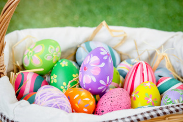 Colorful Easter eggs in the basket on green grass at the yard , festival and holiday spring coming, Easter calibration