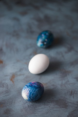  Happy Easter. Easter eggs on a blue surface.