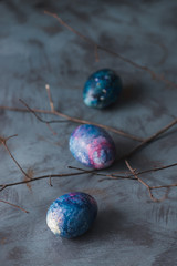  Easter holiday. Easter painted colorful eggs and branch. Blue background.