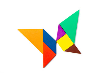 Color wood tangram puzzle in butterfly shape on white background