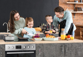 Young family cooking together in kitchen