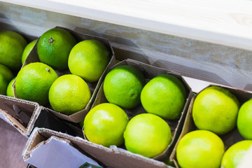 Green limes exposure in cardboard shipping boxes