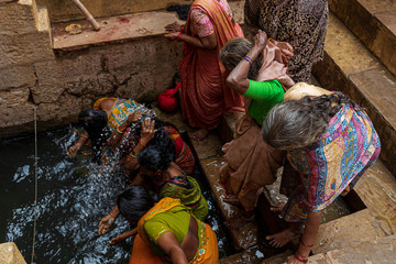 Indian women bathing and washing with water in Varanasi 