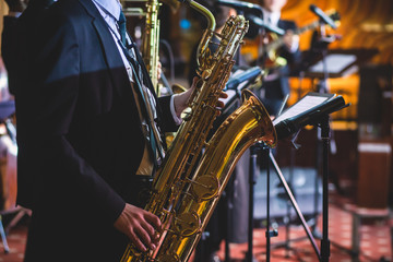 Concert view of a saxophonist, saxophone player with vocalist and musical during jazz band...