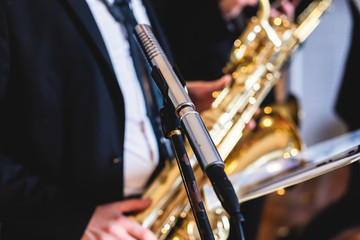 Concert view of a saxophonist, saxophone player with vocalist and musical during jazz band...