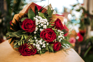 Beautiful fresh flowers bouquet on a counter of florist shop.