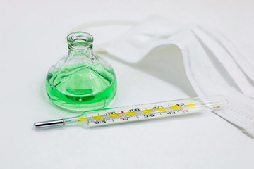  medical mask thermometer on a white background