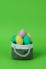 Colorful easter eggs with ceramic basket concept.
