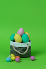 Colorful easter eggs with ceramic basket concept.