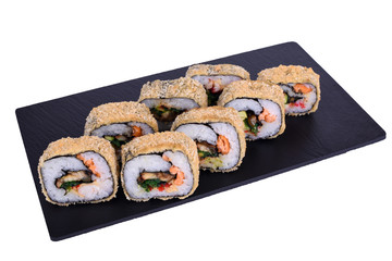 Traditional fresh japanese sushi on black stone Warm Yin Yang Roll on a white background. Roll ingredients: eel, fried salmon, tiger shrimp, red tobiko caviar, hiyashi wakame seaweed, avocado, nori.